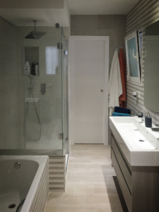 Renovated bathroom with double sink, bath and shower
